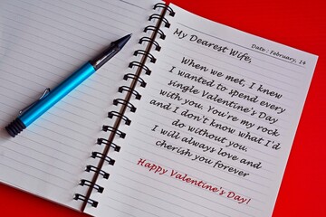 Text on white notepad with red background. Valentine's day concept