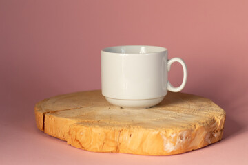 A cup of freshly brewed coffee on wooden cut board. Mug americano on a tree circle cut.