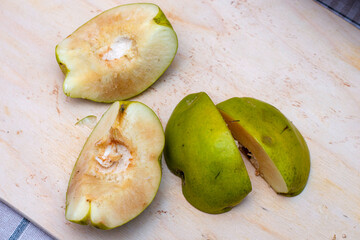 quince cut into four pieces on a wooden board