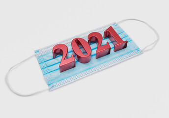 Fototapeta premium 2021 new year numbers lie on medical mask