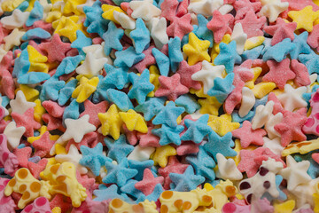 Fototapeta na wymiar Colored fruit candy and caramel in the shape of a stars