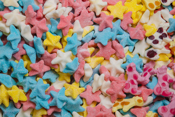 Fototapeta na wymiar Colored fruit candy and caramel in the shape of a stars