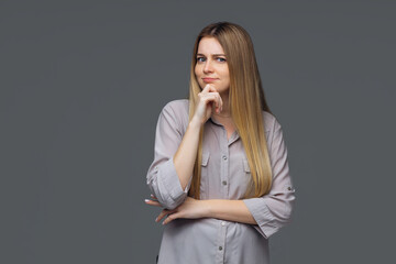 Portrait of dreamy cute lady, youth, people touch chin, think, choose, solve problems, wear fashionable clothes, isolated gray background