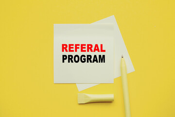 REFERAL PROGRAM. Word on YELLOW sticker with YELLOW pen and yellow background. a bright solution for business, financial, marketing concept
