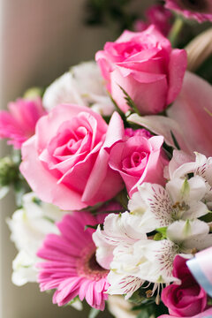 Vertical image of fresh pink rose flowers bouquet in a natural soft light tone and copy space with selective focus.