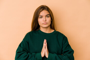 Young skinny caucasian teenager girl praying, showing devotion, religious person looking for divine...