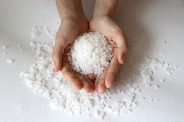 Sea salt. hands holding sea salt from Dead sea.