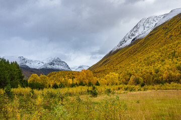 Valley of Kåfjorddalen with snow mountains