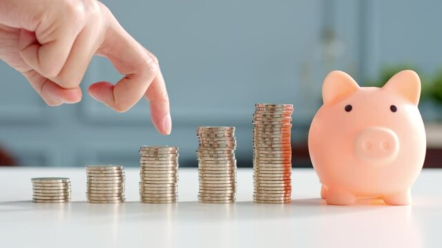 Closeup man hand finger step up on stacking coins, save money and growth concept