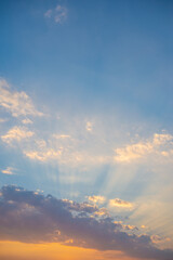 Naklejka na ściany i meble Evening sky and sun shining through the clouds