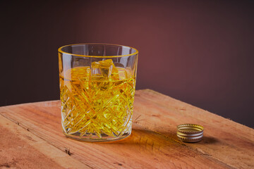 Glass of whisky,on a wooden table.