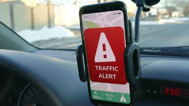 Smartphone GPS app alerting the driver of the vehicle that there is traffic ahead on his route.