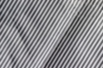 Diagonal striped fabric texture. White and gray textile background