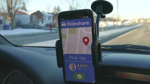 Rideshare app on a smartphone showing the driver a new request while driving