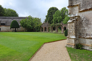 DORCHESTER, DORSET, UK - AUGUST 21ST 2020: A grave path leads round an English stately home, by a lush lawn