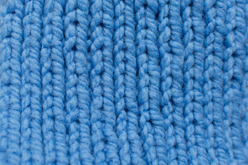 Plakat close-up pattern, knitted with blue threads. Horizontal photo. background for presentation of work or text.