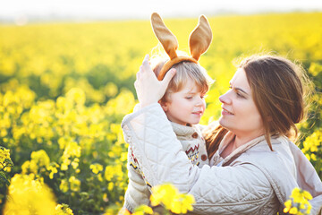 Little toddler child and his mother in Easter bunny ears having