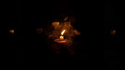 burning candle on a dark background