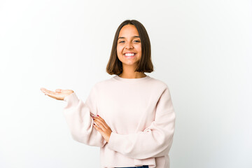 Young mixed race woman showing a copy space on a palm and holding another hand on waist.