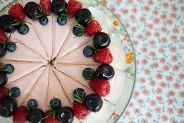 Fototapeta na wymiar Set of cake cream rose decoration with fresh raspberries and fresh berries slices.