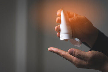 A man is opening the small gel for washing hand, to protech corona virus in office