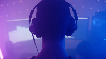 RGB gamer silhouette head with headphones listening to music