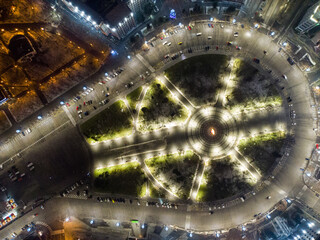 Aerial night look down fly up view with holidays illumination lights of Freedom Svobody Square central circle circus ornament Kharkiv, Ukraine