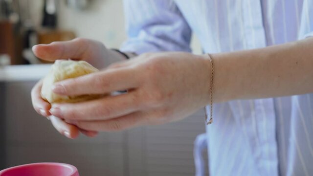 The woman sheff puts the finished dough in a mold for the preparation of the Easter cake. Raw dough with close-up raisins, cooking for the holidays