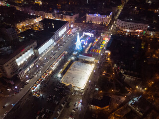 Freedom Svobody Square (Kharkiv) aerial drone view at night with New year holidays and Christmas tree decorations with colorful illumination in city center
