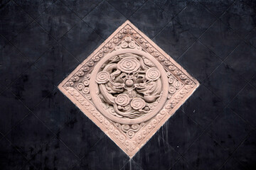 Chinese dragon sculpture on the black brick wall