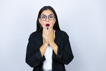 Beautiful business woman shocked covering mouth with hands for mistake. secret concept.