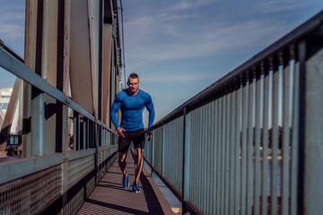 Young handsome man training hard. Man doing sports outside. Outdoors recreation, stretching and training fit body