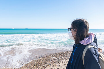 Girl with face mask at the beach