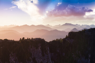 Beautiful aerial landscape view of Mountain Peaks near Vancouver, British Columbia, Canada. Colorful Cloudy Sunset Sky Art Render.