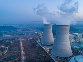 Nuclear power plant after sunset. Dusk landscape with big chimneys.At dusk, the thermal power...