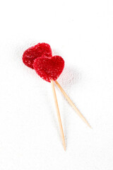 Valentine's Day, two red heart cranberry marmalade on a wooden stick on a white background