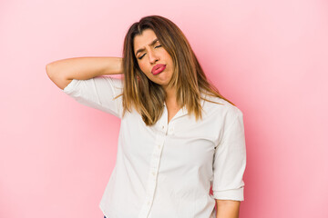 Obraz premium Young indian woman isolated on pink background having a neck pain due to stress, massaging and touching it with hand.