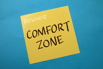 Comfort zone, text words typography written on paper against blue background, life and business motivational inspirational