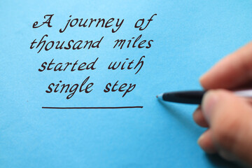 Journey of thousand miles started with single step, text words typography written on blue...