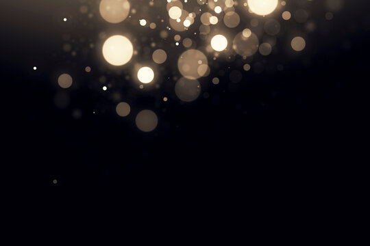 Abstract golden bokeh lights on black background with shiny particles. light gold effect image