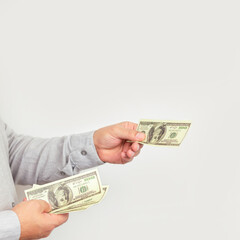 Businessman giving money us dollar bills close-up