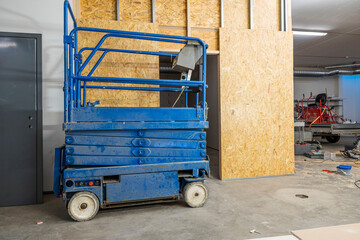 View of on working place with scissor lift. Construction work concept.
