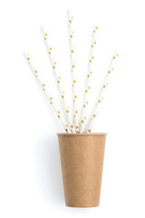 Brown paper cup in hand with straws, on a white background. Paper tubes with stars.