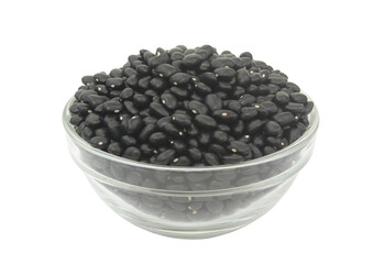 Black beans in glass bowl isolated on white background