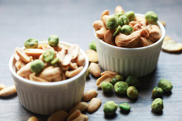 cashew nuts and Green pea good snack food healthy and delicious food in white bowl  put on wood table 