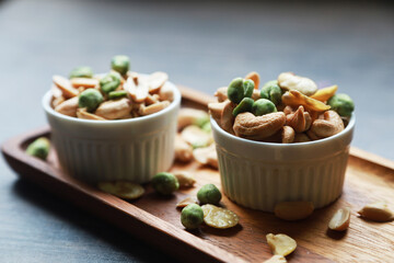 cashew nuts and Green pea good snack food healthy and delicious food in white bowl  put on wood table 