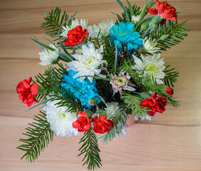 Beautiful bouquet of flowers on a wooden surface top view. Flower arrangement.