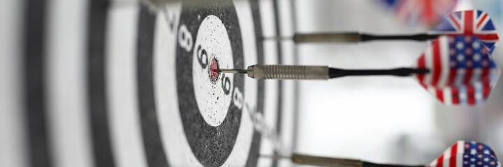 Naklejka premium The darts bear the flags of the United States and Britain. International darts competition. Success oriented concept