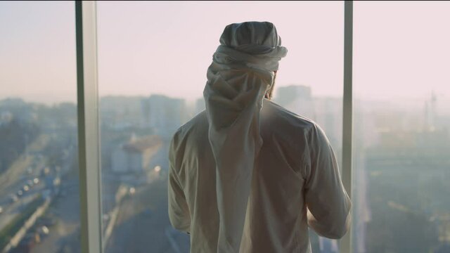 Arabic Young Businessman Walking into Office Cabinet Looking through Papers Thinking about Investment Business Economy in Modern City.
