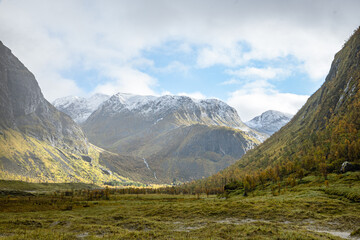 Fototapeta premium Snow mountains with a cloudy sky in north Norway